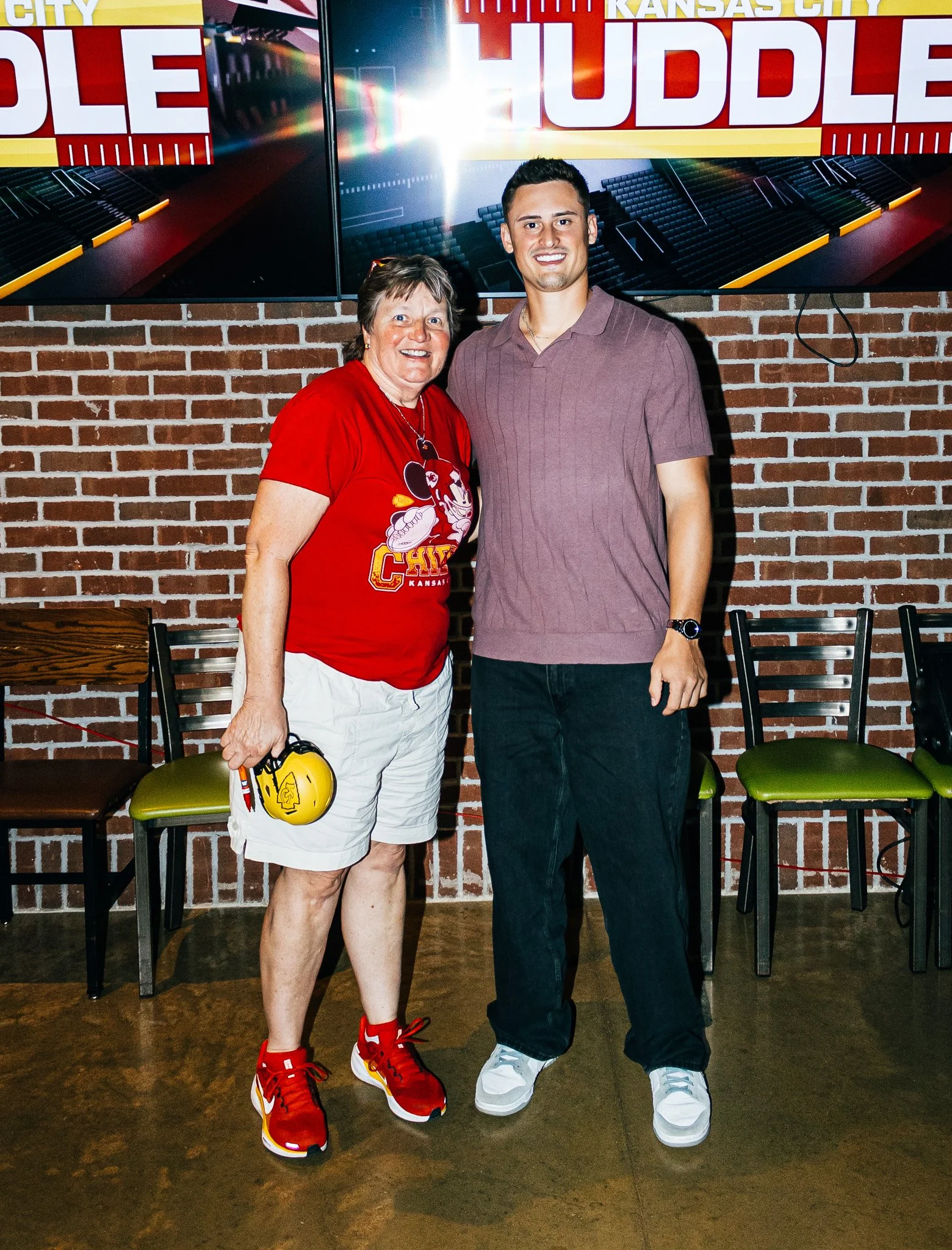 Matt Araiza posing for a picture with a fan during the live taping of Kansas City Huddle