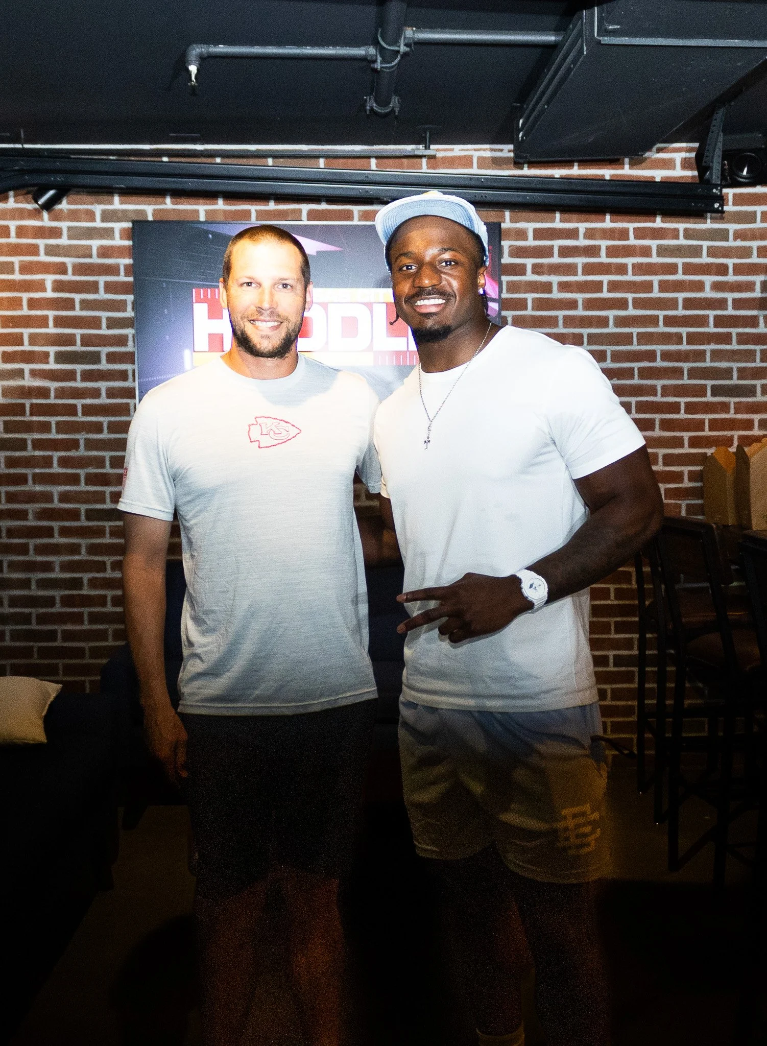 Jeffrey Bassa posing with a fan at Kansas City Huddle at Chicken N Pickle