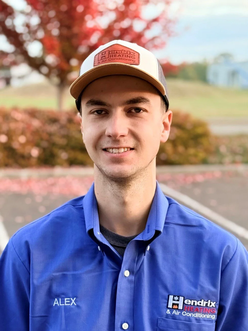 Man wearing Hendrix Heating & Air Conditioning shirt and cap outdoors