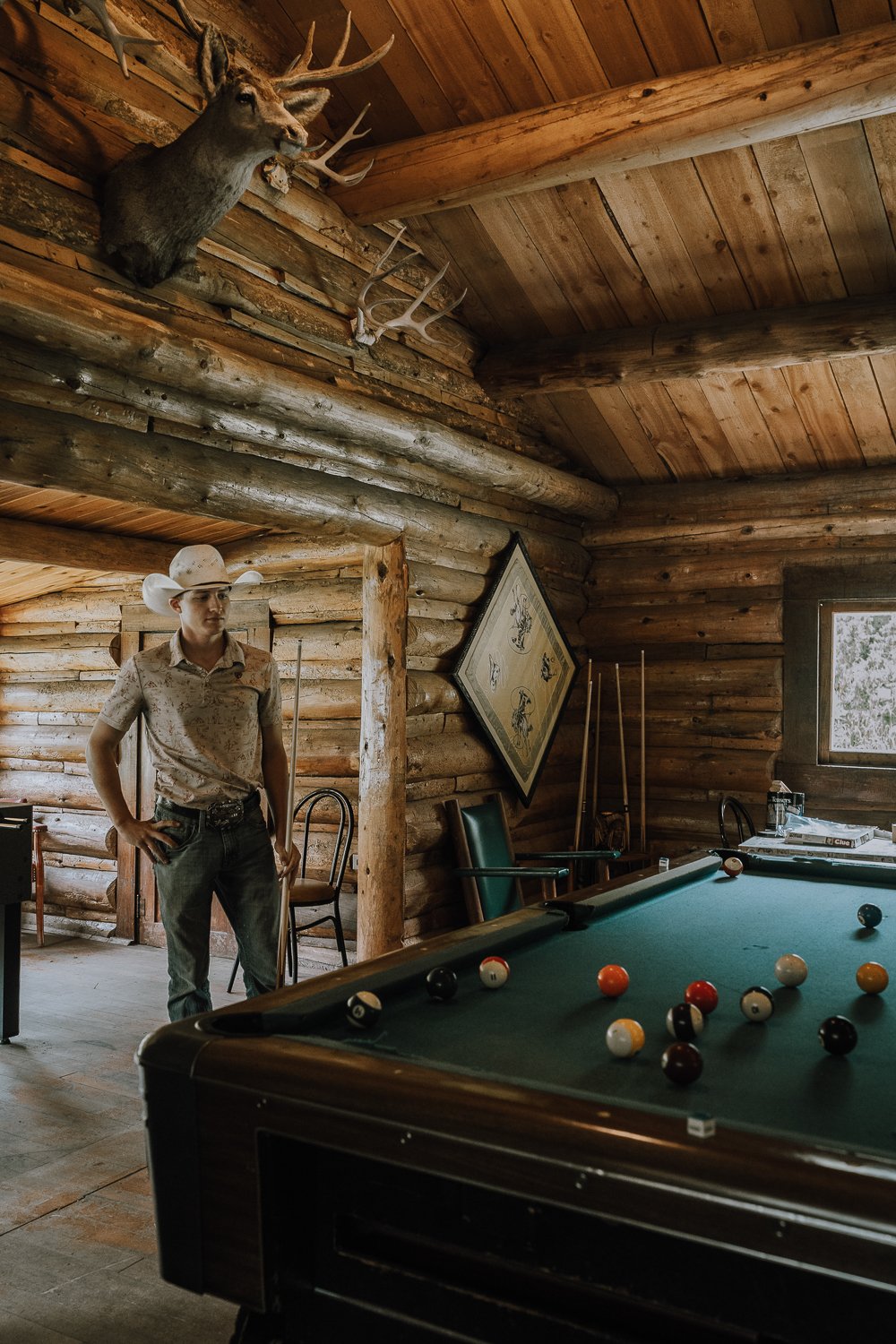 A dude ranch guest in the rec room at Blackwater Creek Ranch.