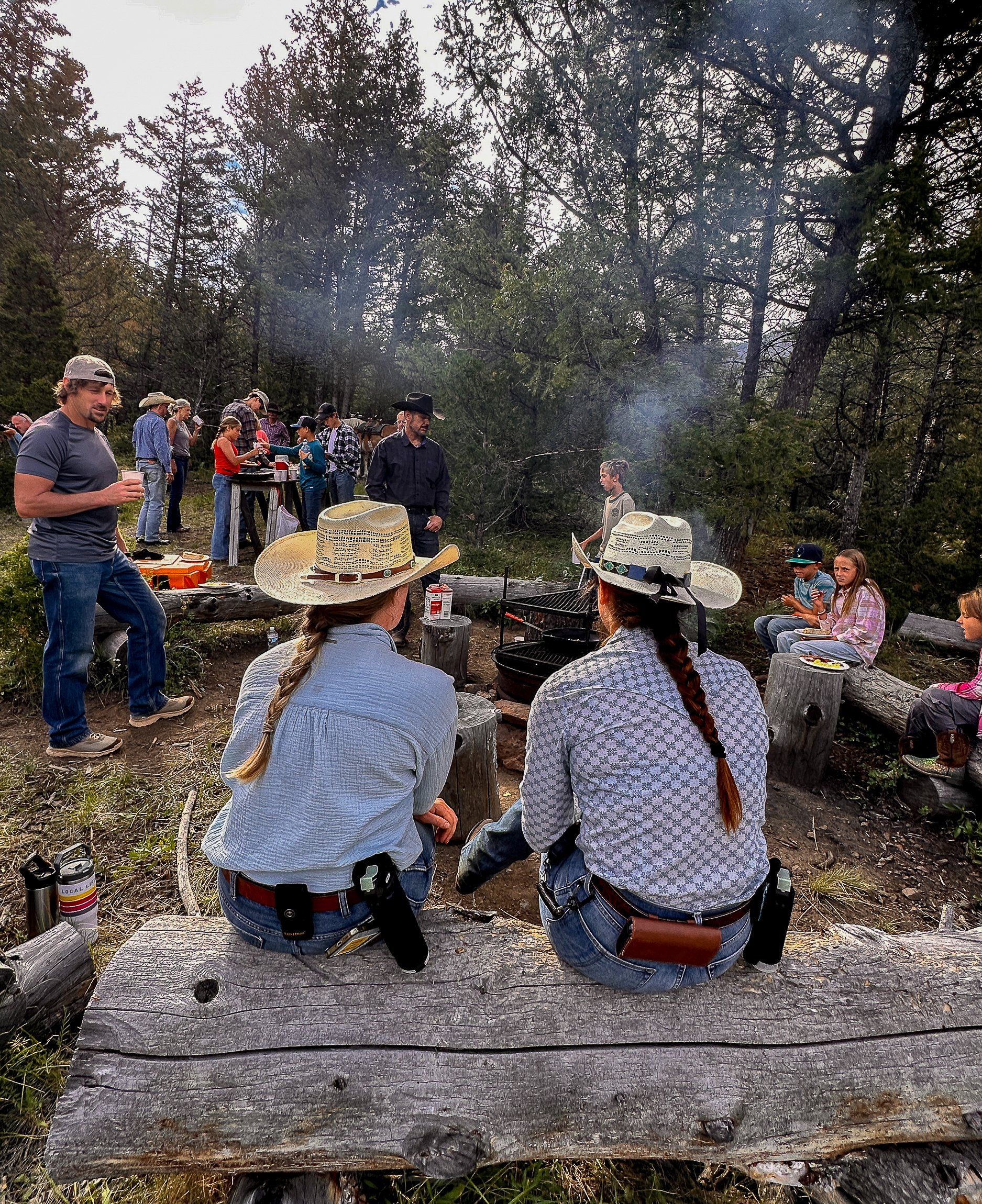 Dude ranch guests gather around the campfire during a breakfast ride. 