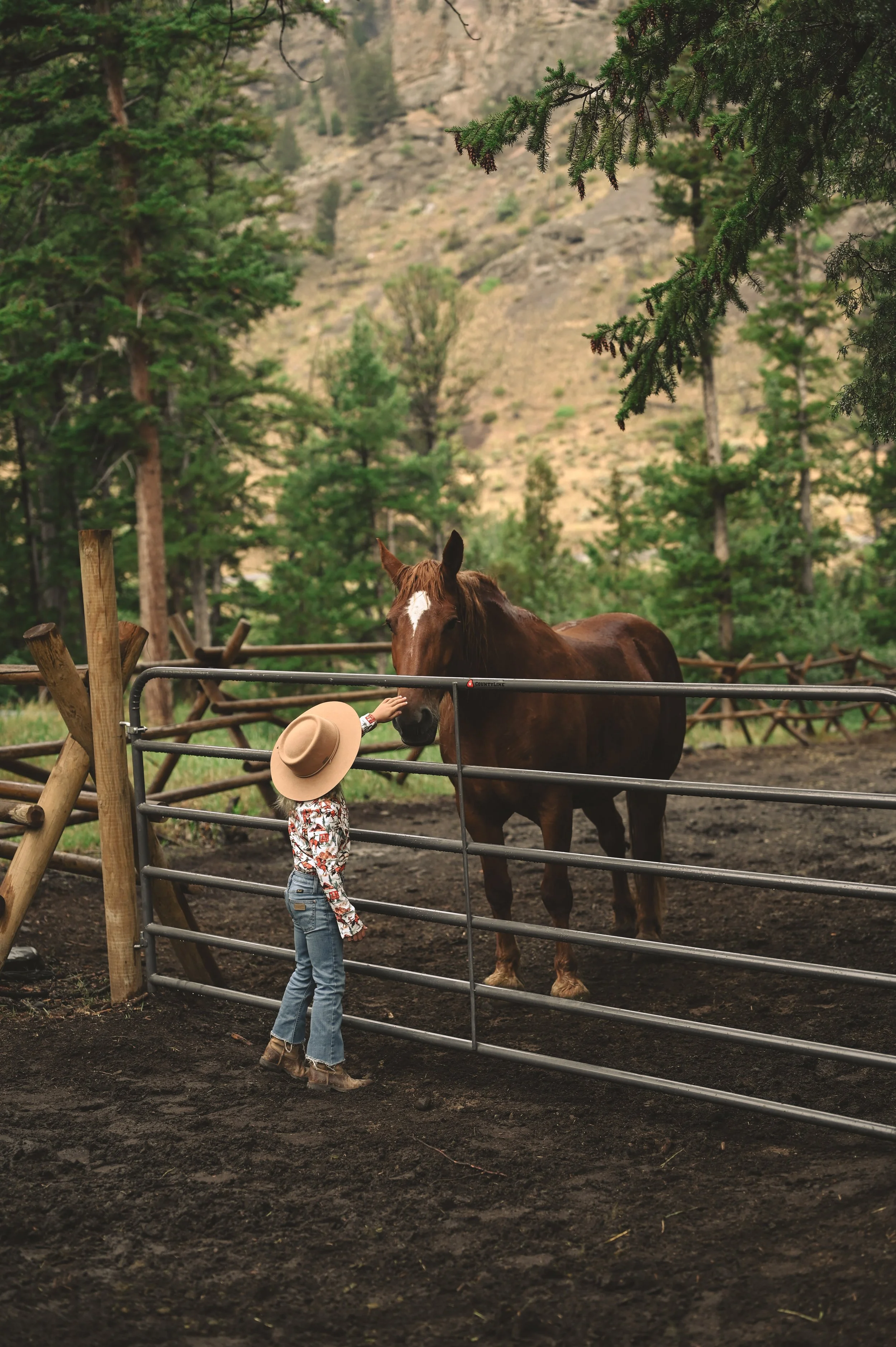 A child with a horse on a dude ranch vacation.