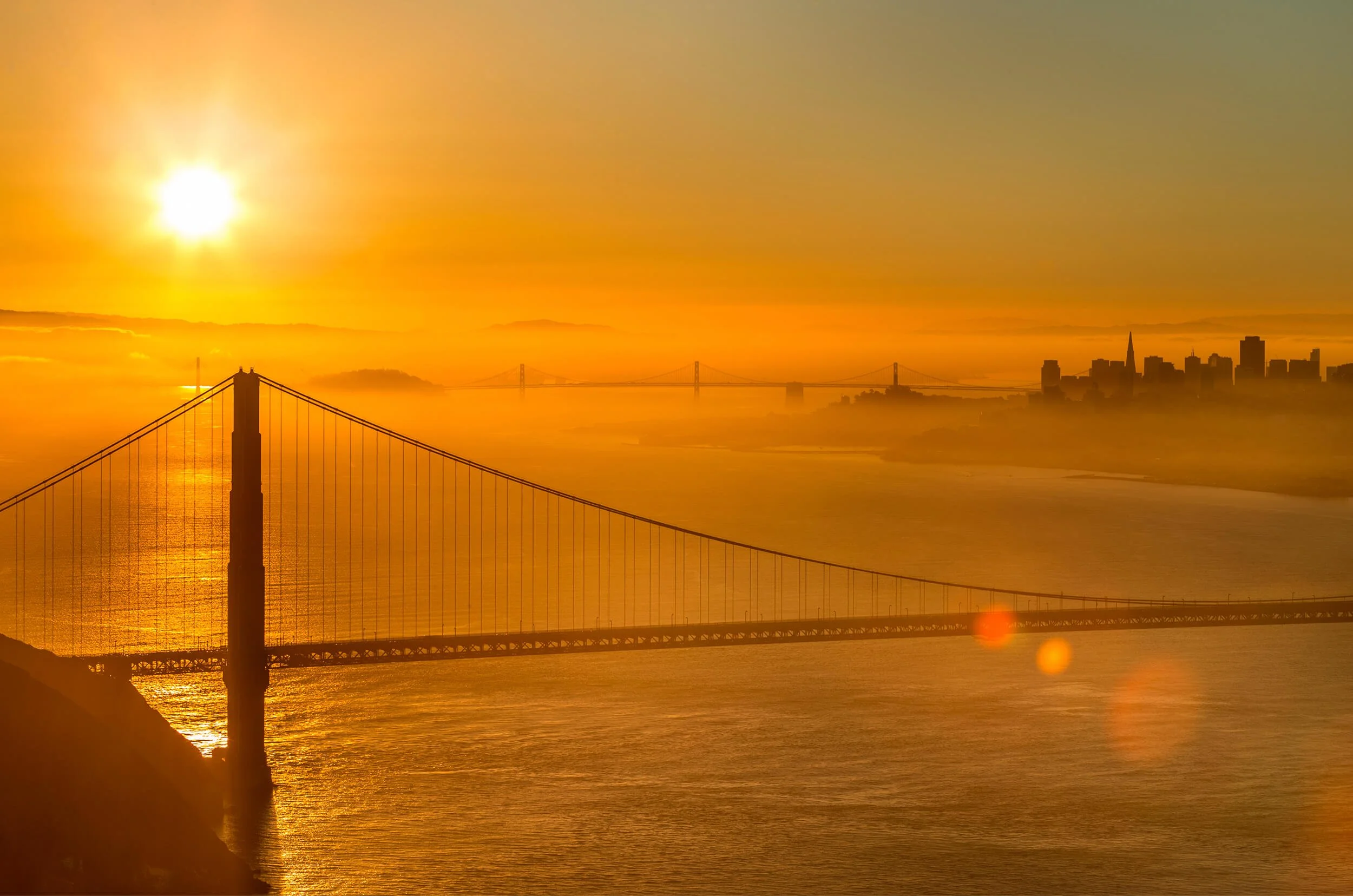 The Golden Gate Bridge and the ocean during sunset.