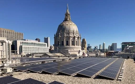 Solar panels generating electricity with San Francisco City Hall in the background