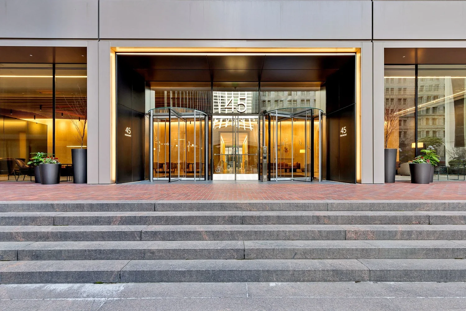 A staircase entrance into a glass building.