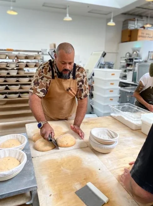 Azikiwee Anderson cutting bread
