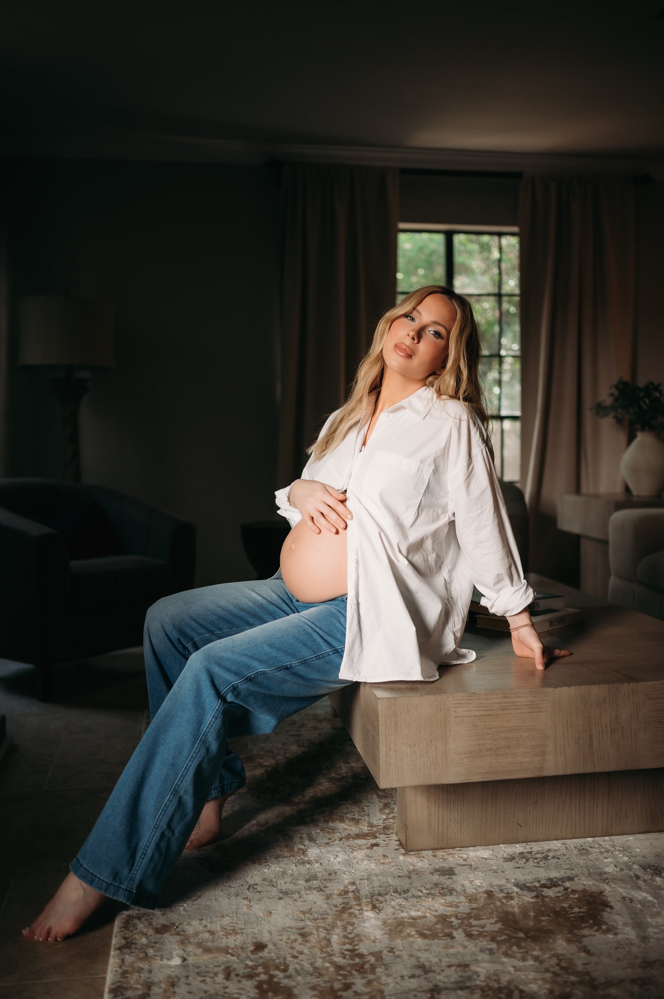 pregnant mother sitting relaxed during in-home maternity session Houston TX