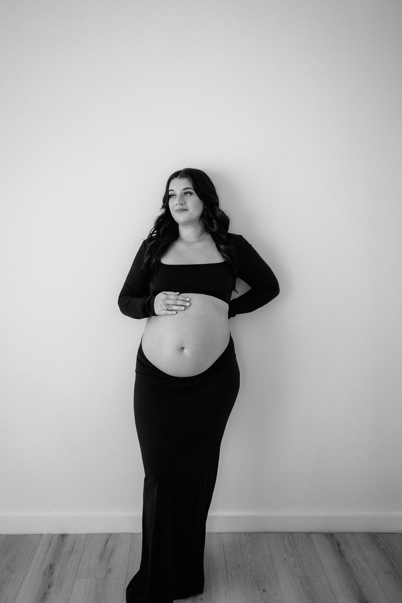 mama embracing her pregnant belly during maternity photoshoot in conroe, texas