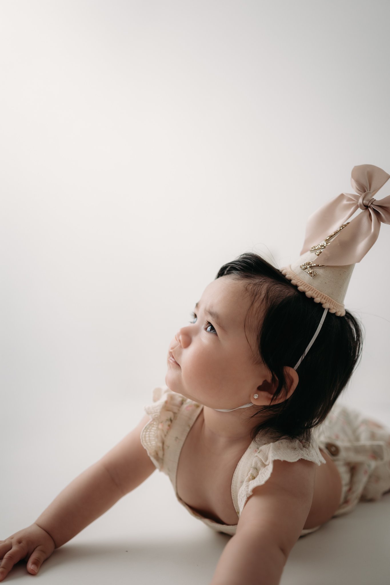 One-year-old baby girl celebrating her first birthday during a Houston milestone photography session