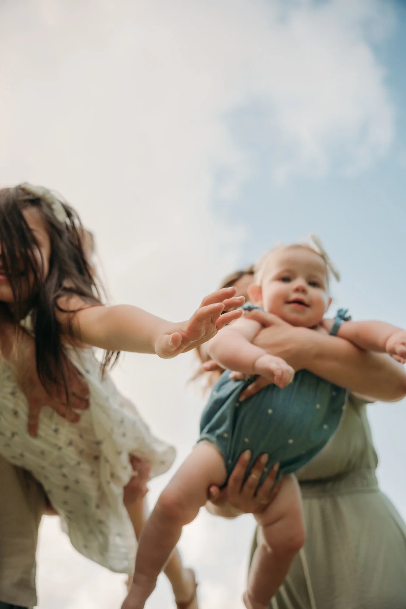 outdoor family photographer in the woodlands, tx poses a family for a fun family outdoor session