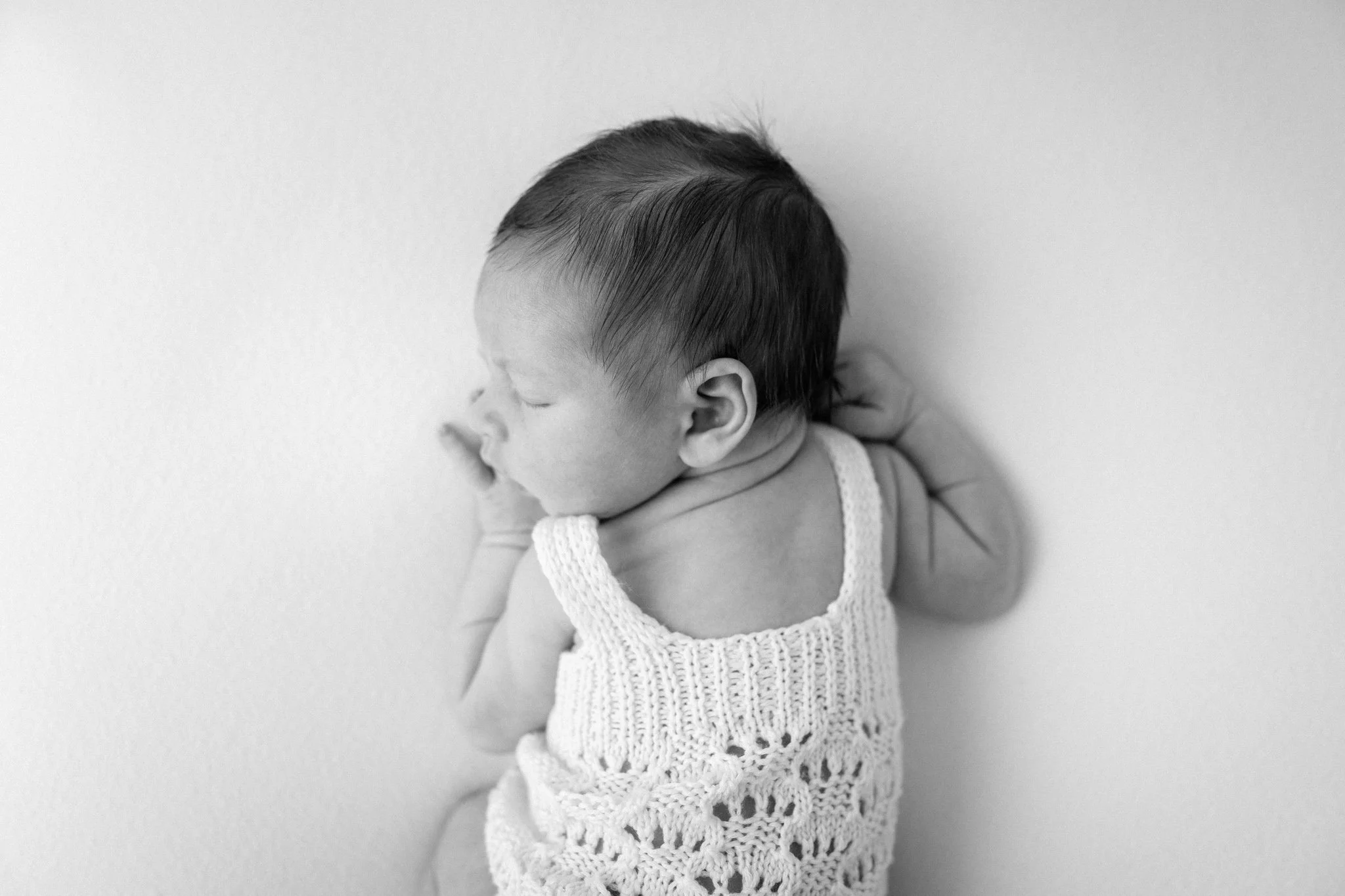 newborn baby on a white background at studio brae, the woodlands studio photographer