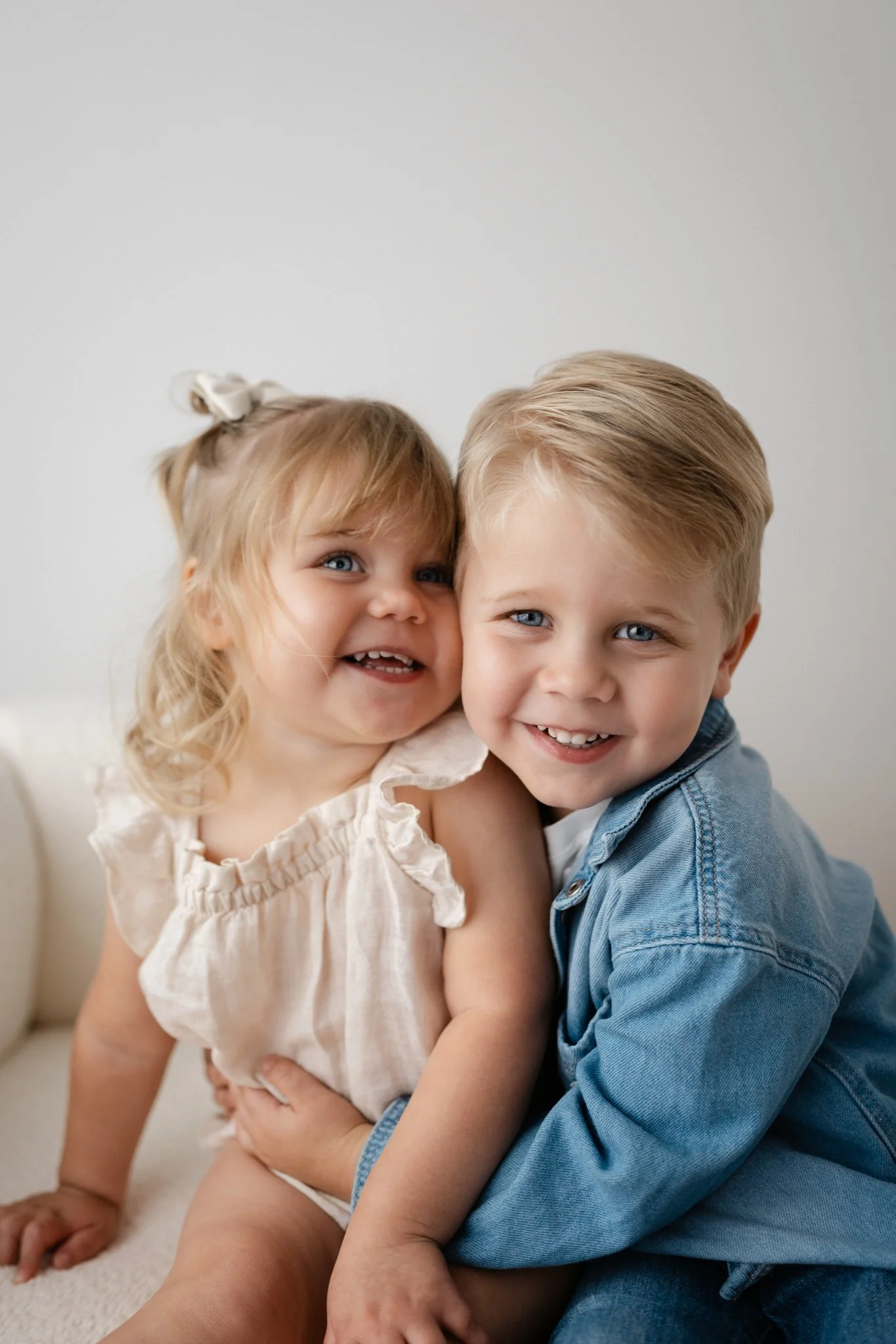 two siblings embrace for a photo in the woodlands, texas photography studio