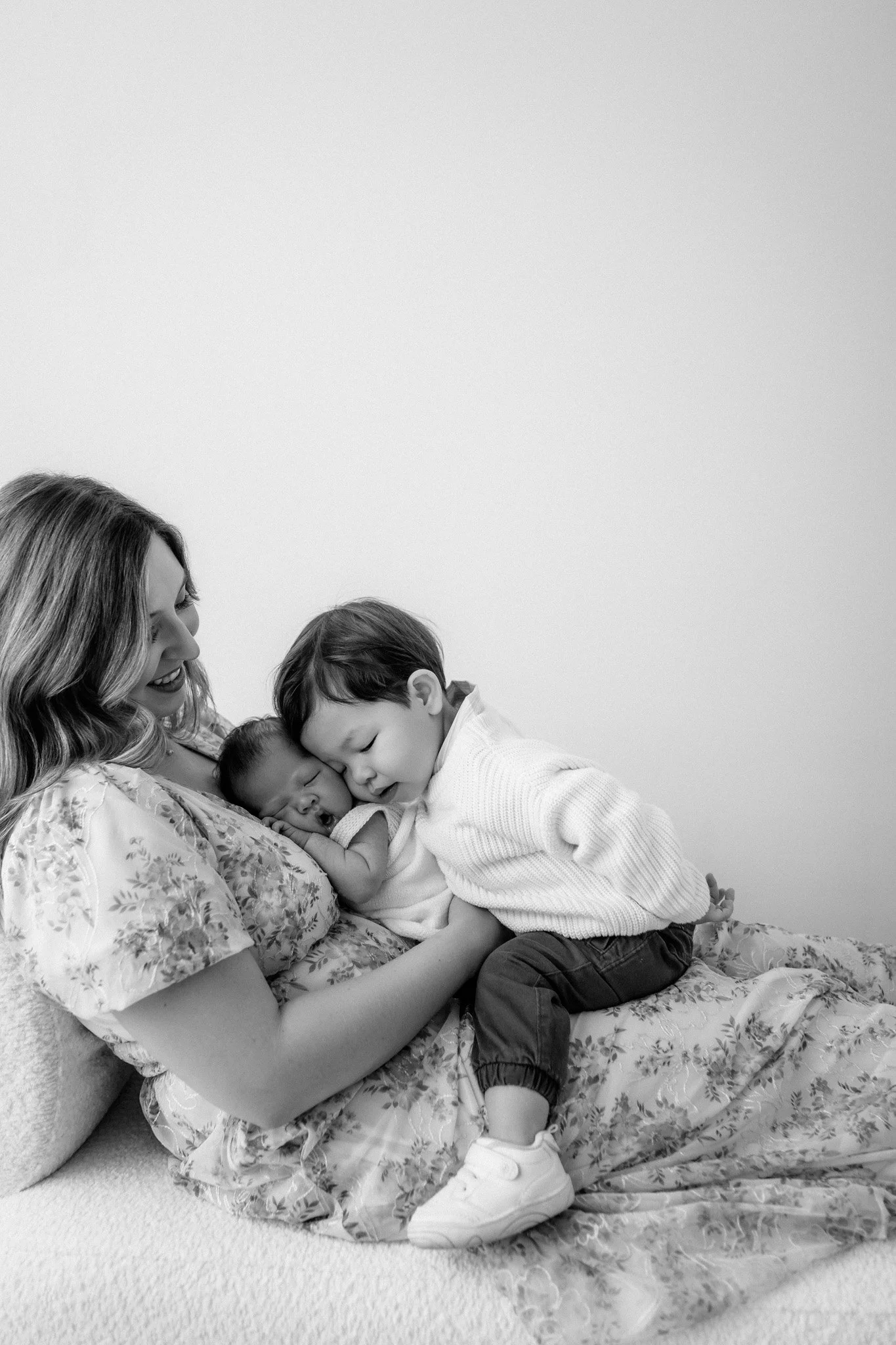 mom poses with her newborn and toddler for a newborn session in the woodlands with photographer, studio brae
