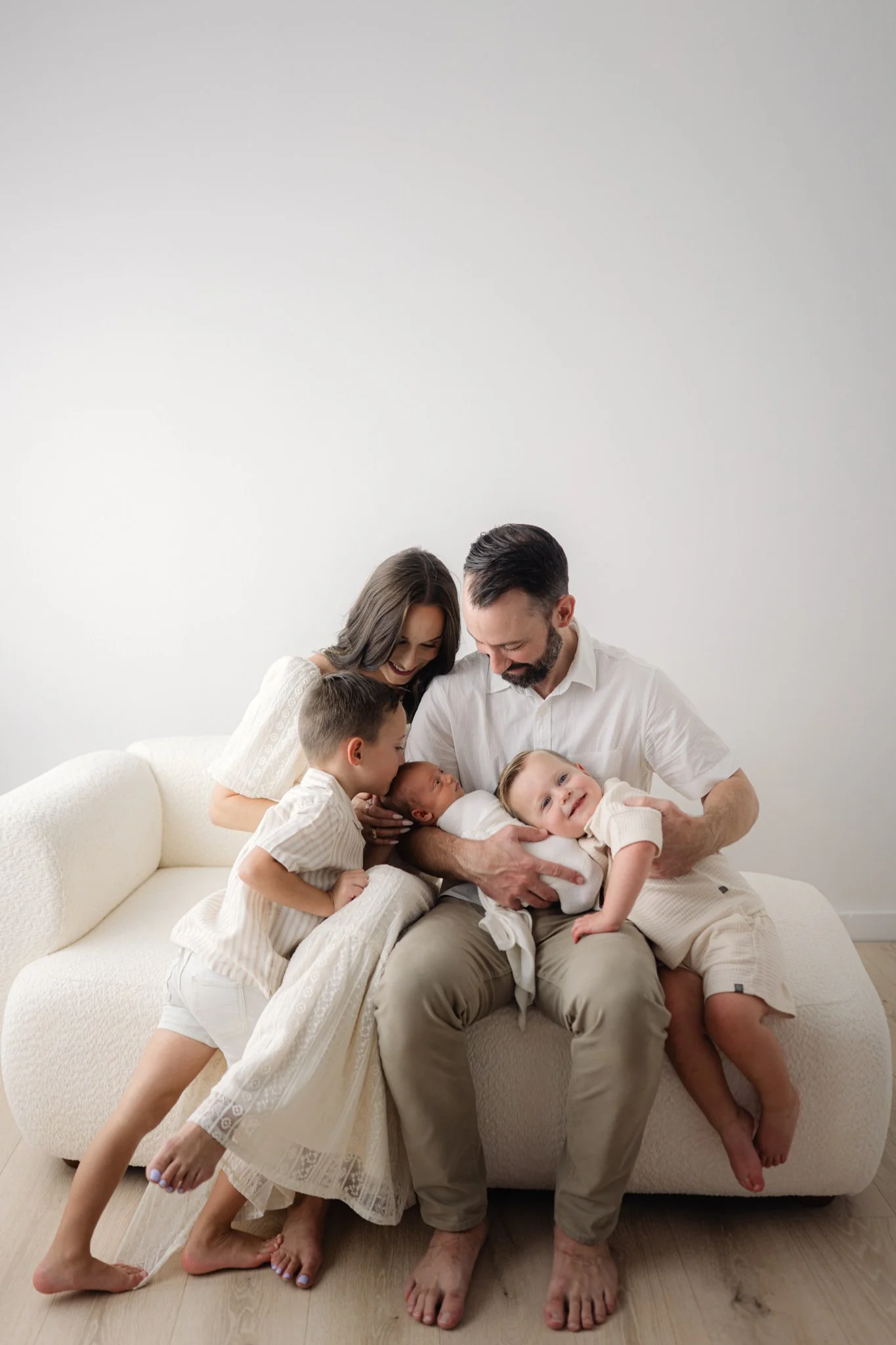 family holding newborn baby for their newborn session in the woodlands, texas