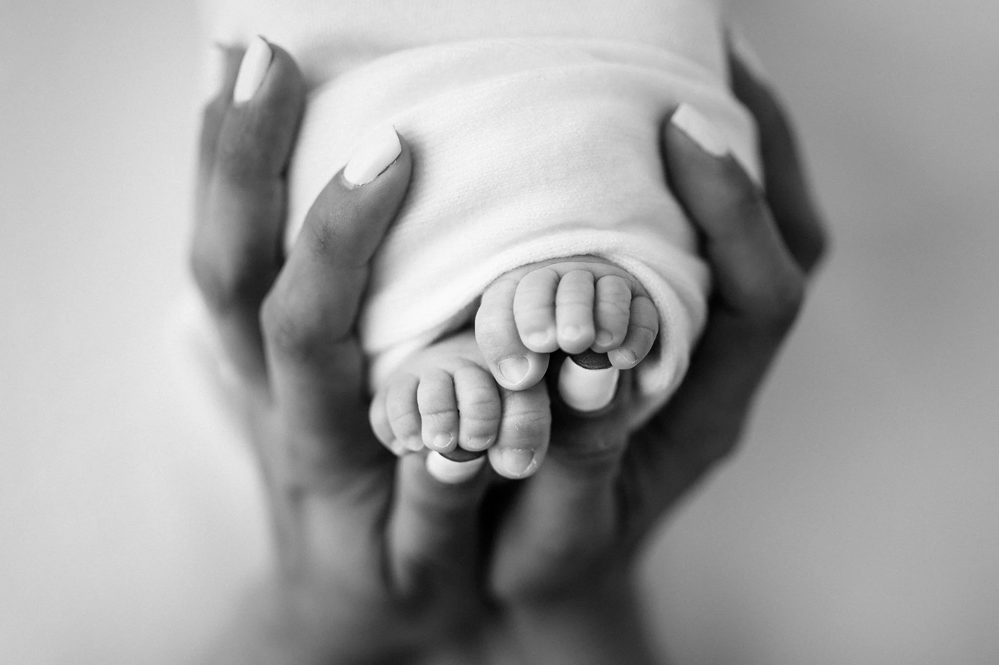 black and white close up of newborn baby toes during studio session The Woodlands TX