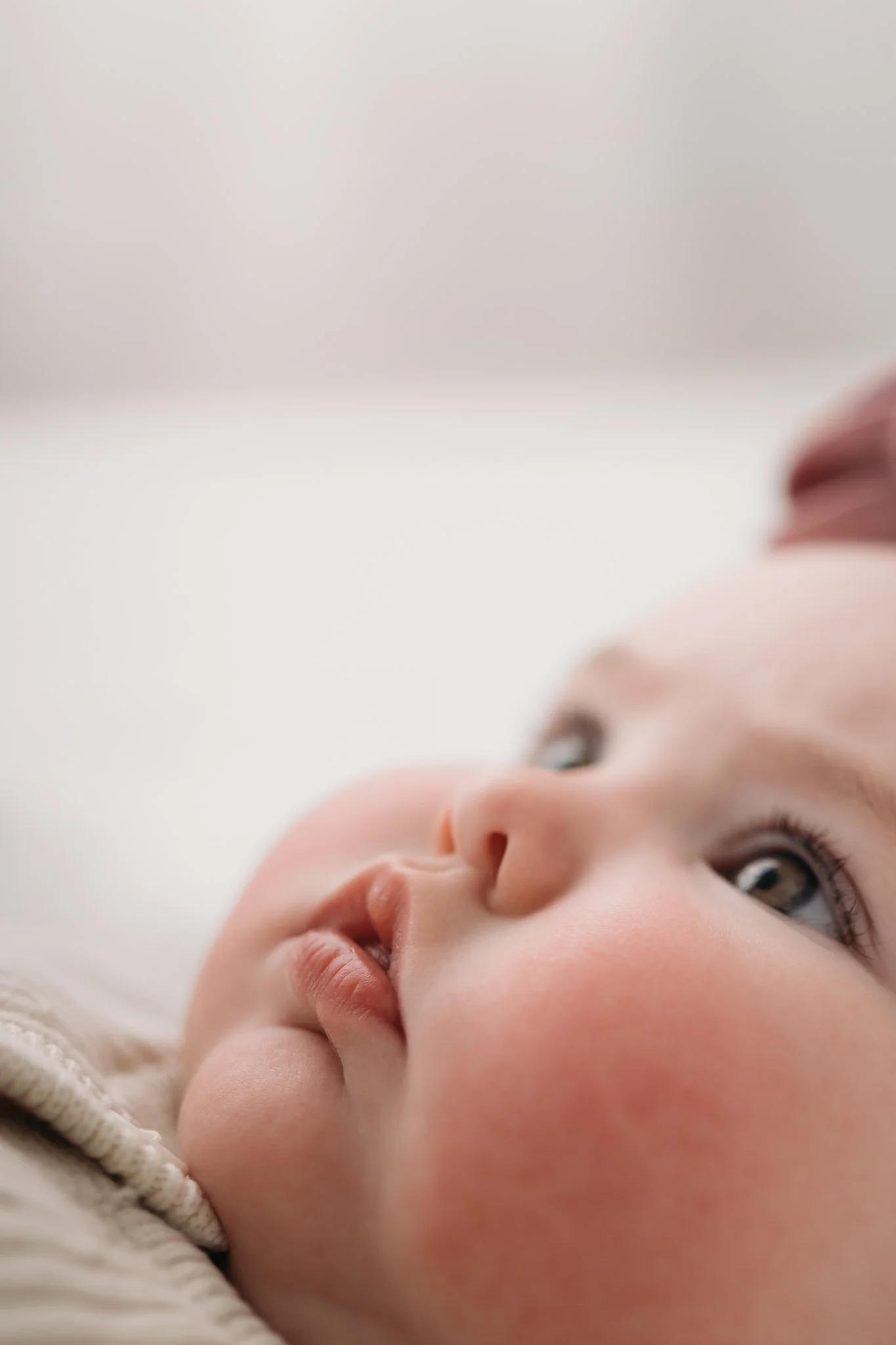 close up of baby face and blue eyes during milestone session Houston TX