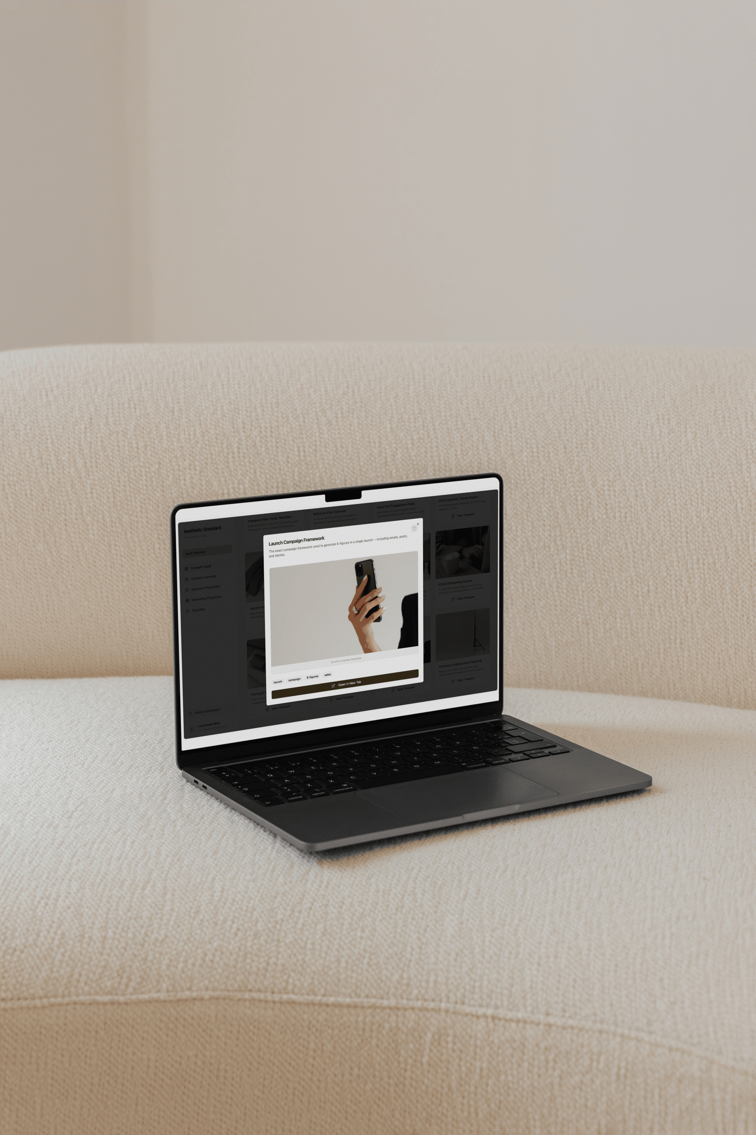 a computer on a beige couch showing a template for a promotion idea for a med spa