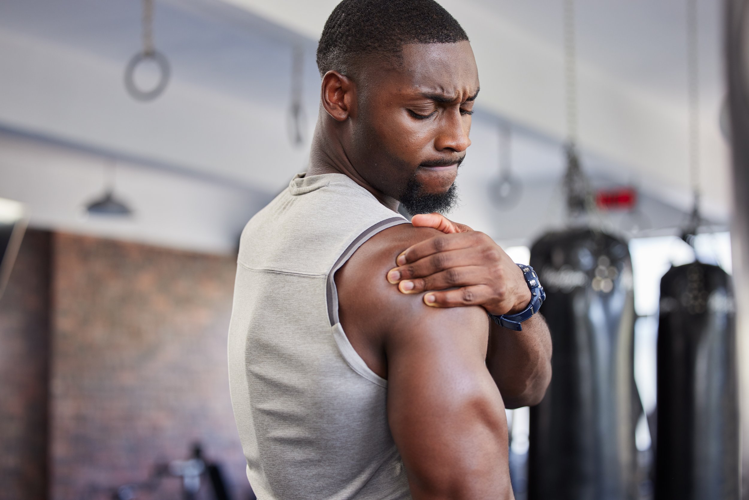 Person experiencing shoulder pain, representing common shoulder injuries and rotator cuff symptoms.