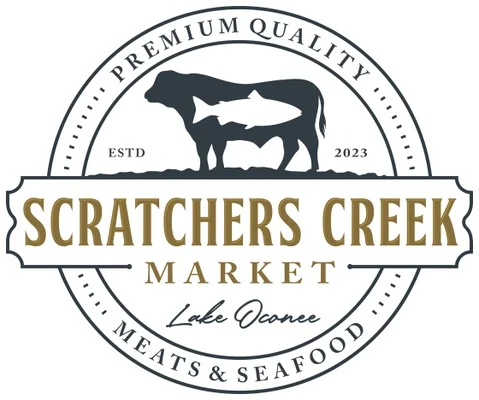 A circular logo for Scratchers Creek Market, featuring a silhouette of a cow with a fish inside it, surrounded by text indicating 'Premium Quality,' 'Lake Oconee,' and 'Meats & Seafood,' established in 2023.