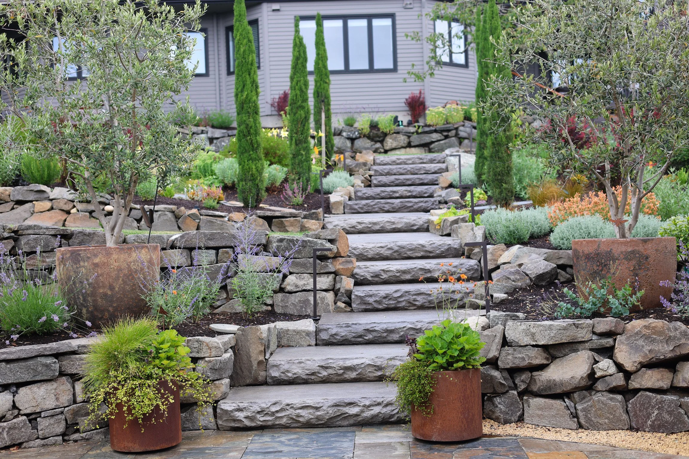 Rather than replace the stairs, we darkened the concrete to better integrate them with the garden.