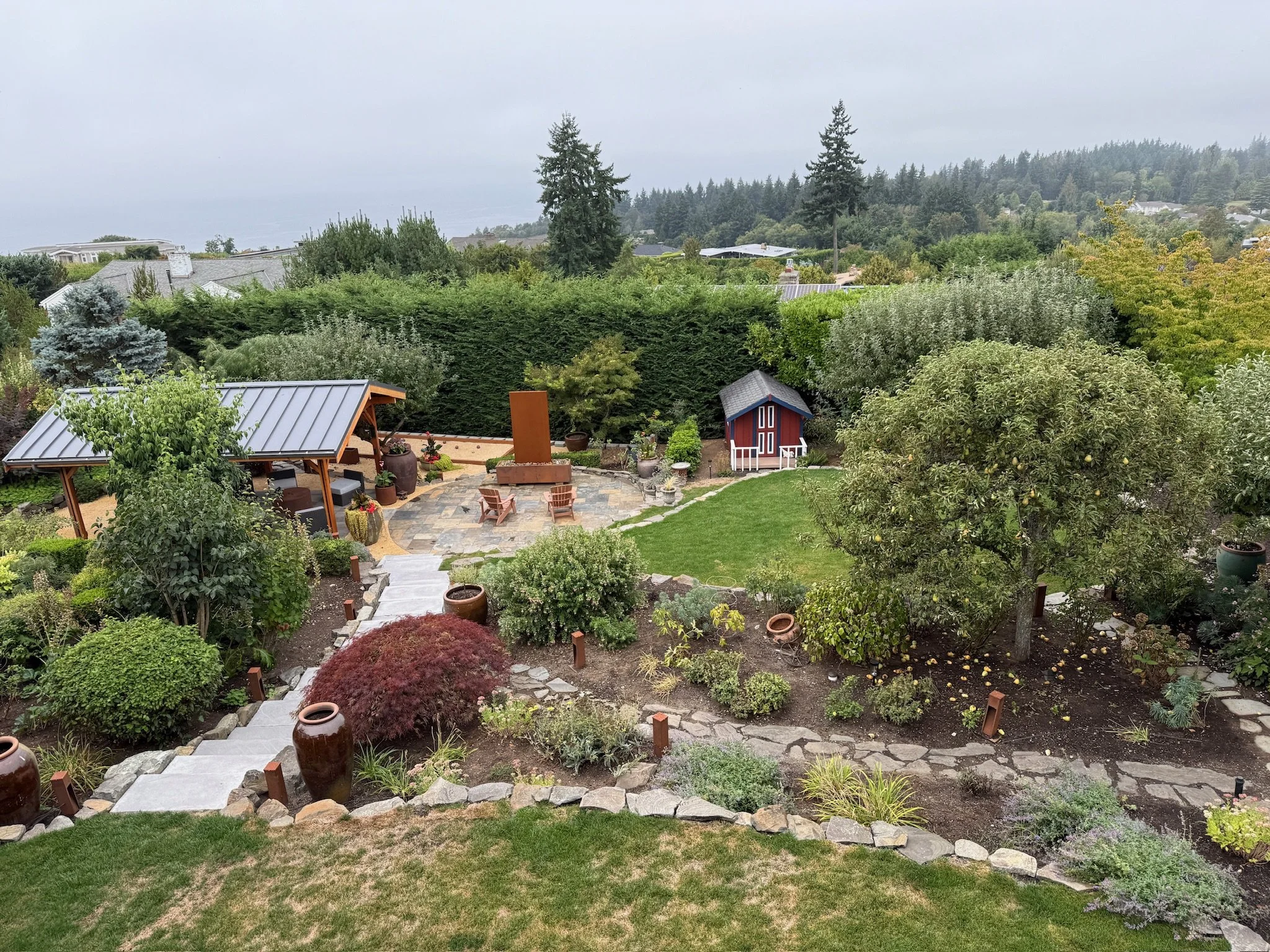 Overgrown shrubs and expansive lawn were replaced with a more generous and layered planting scheme.