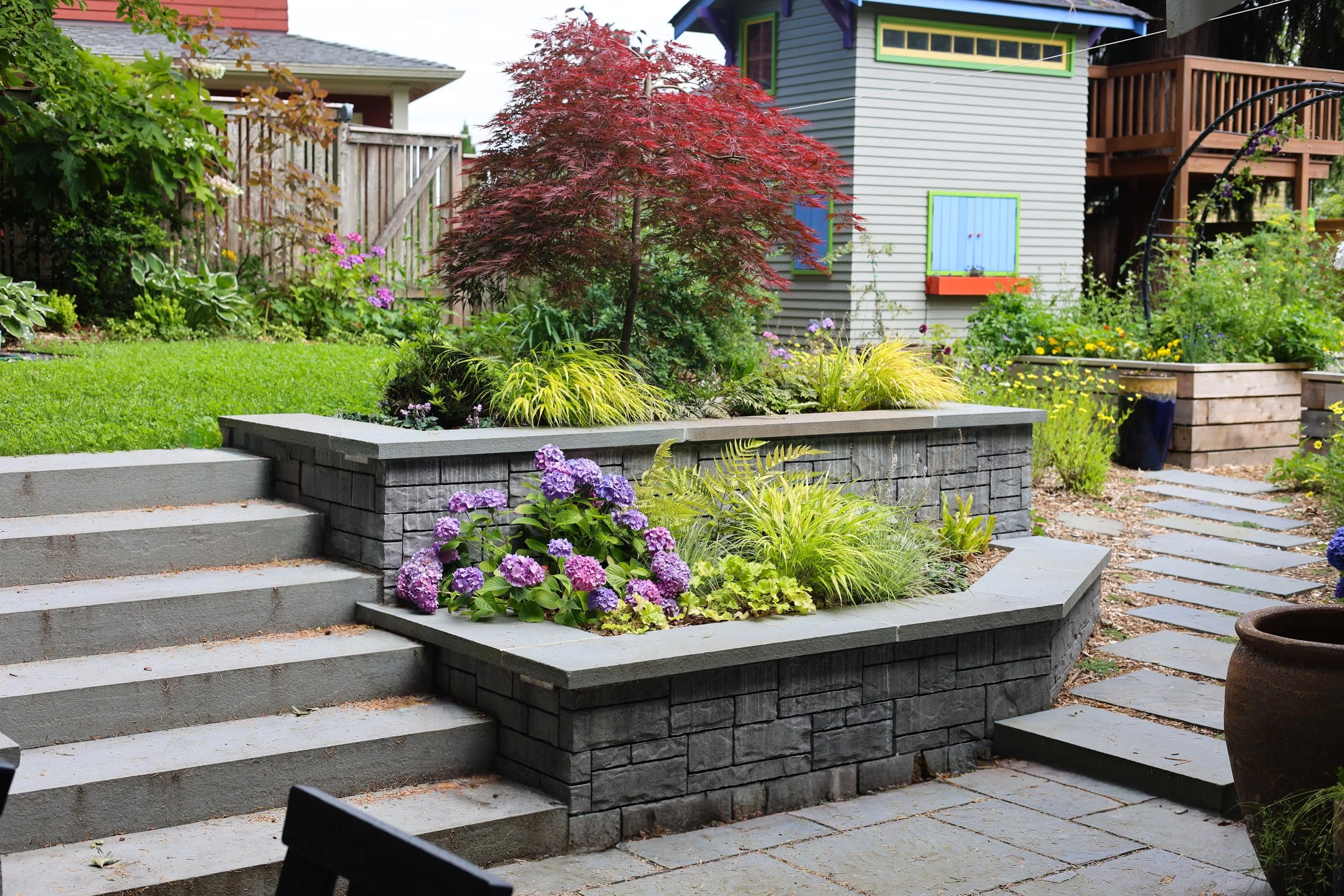 The now-visible terraced walls are a beautiful feature to enjoy—and double as extra seating.