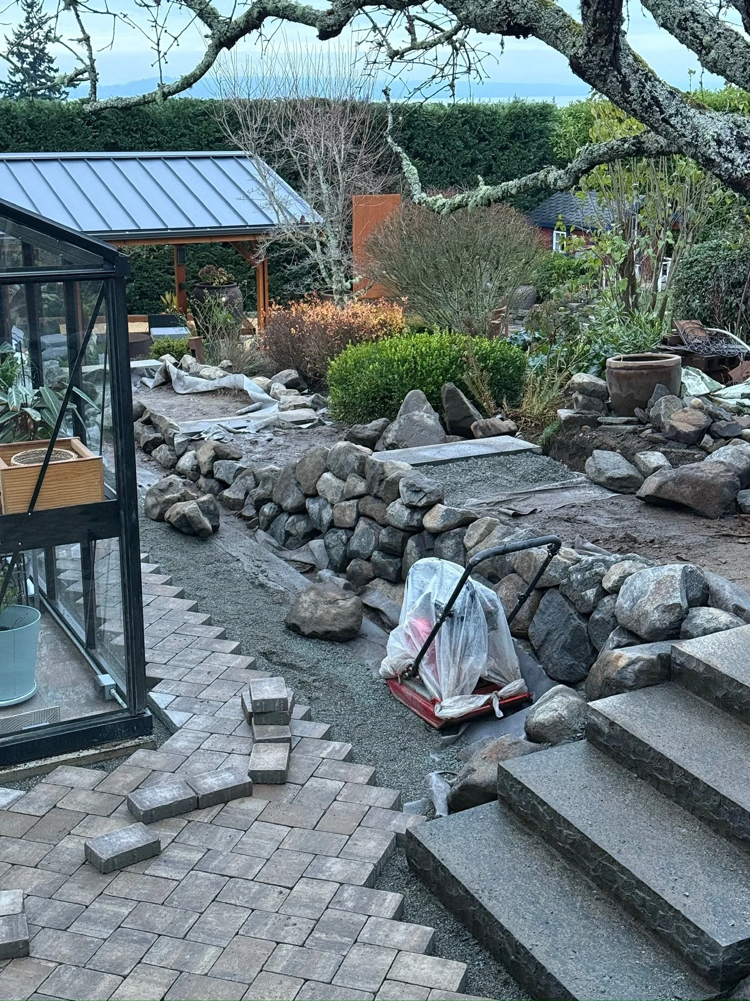 The project began with a simple recommendation: design a patio to frame the greenhouse.