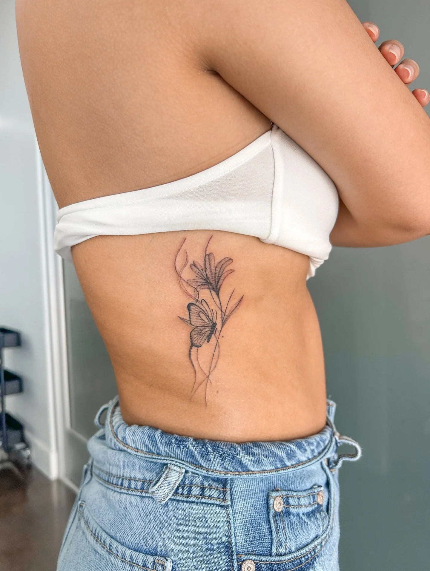 My client drove all the way from Bakersfield for this tattoo and said it was worth the drive 🥹❤️

She requested a butterfly with an X-ray flower and some thin, smoky lines in the background. This is her second tattoo ever and she took on a rib place