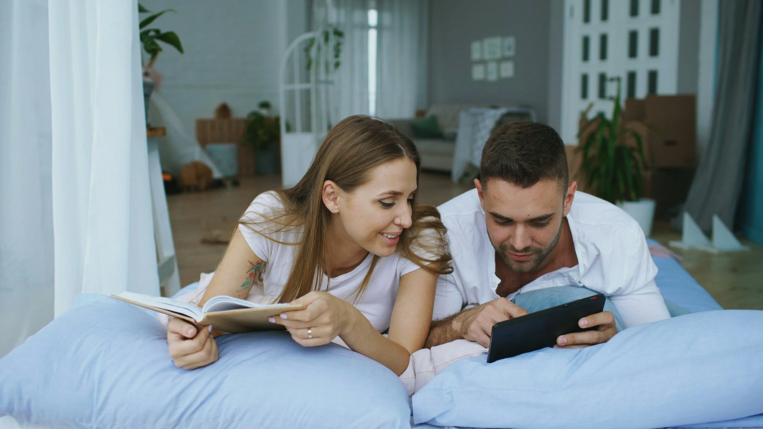 Couple looking through a tablet together while discussing hopes and goals during their fertility journey.