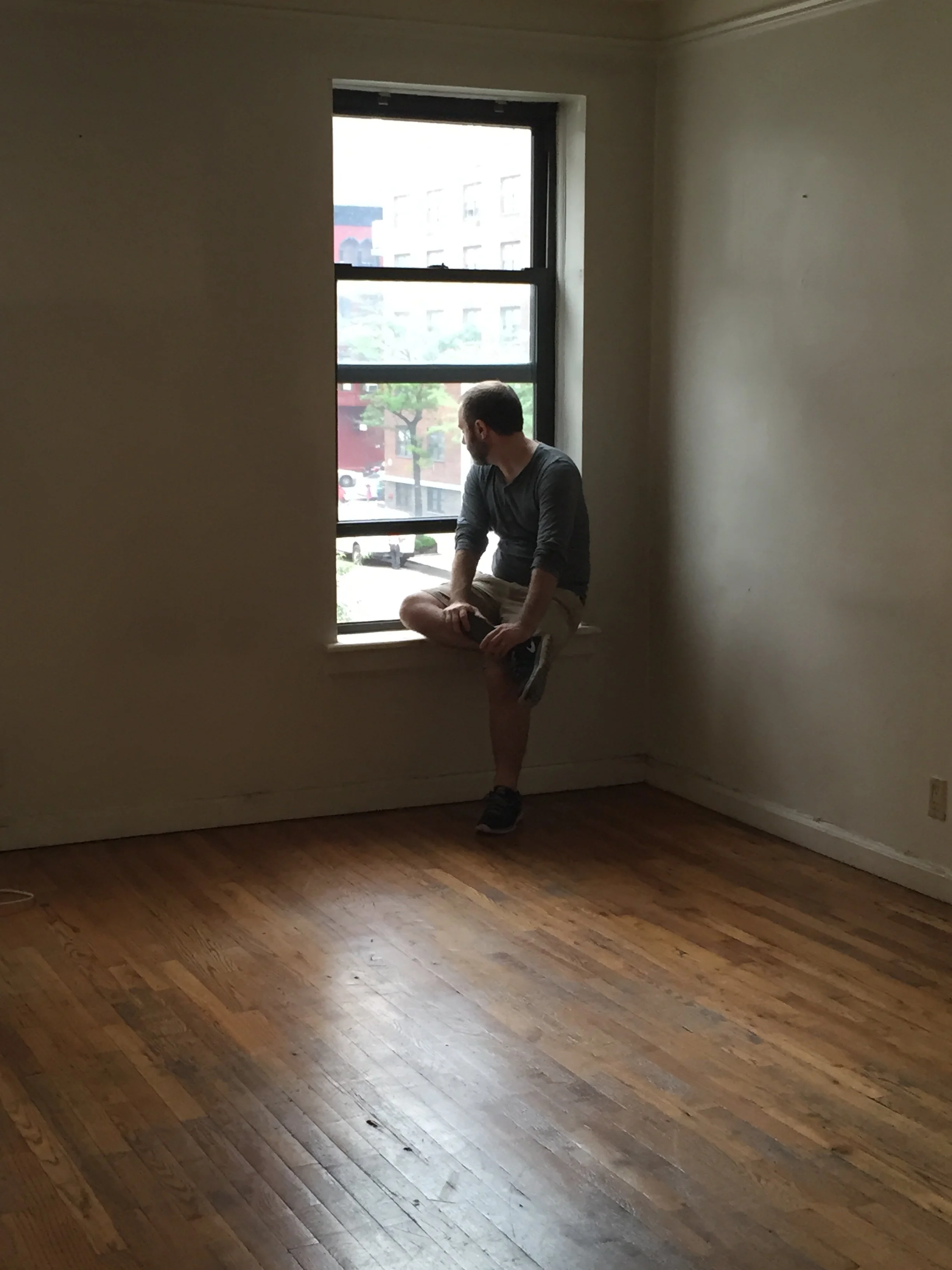 The author in a window overlooking East 81st St in Manhattan, 2016.