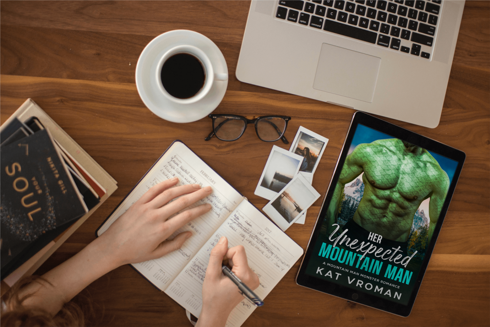 Her Unexpected Mountain Man by Kat Vroman on tablet, Woman's hands, writing in book, coffee, laptop