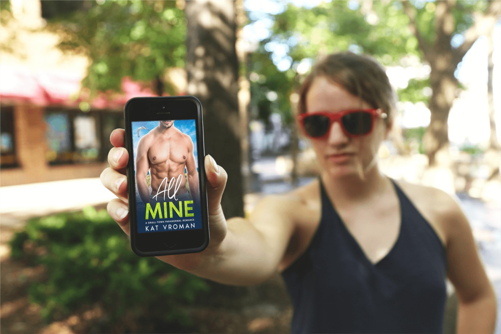 All Mine by Kat Vroman on phone with woman holding it out