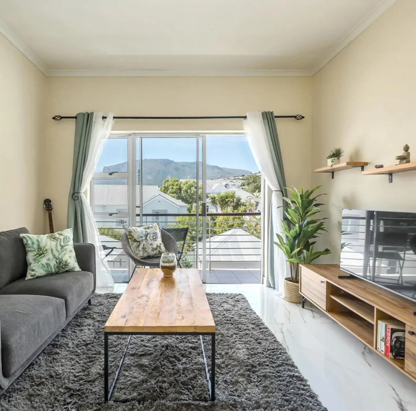 Wake to mountain silhouettes and unwind to golden sunsets. This modern coastal retreat blends warm, neutral interiors with effortless comfort, creating a calm, inviting space to slow down and settle in. Soft natural light fills the bedroom, framing s