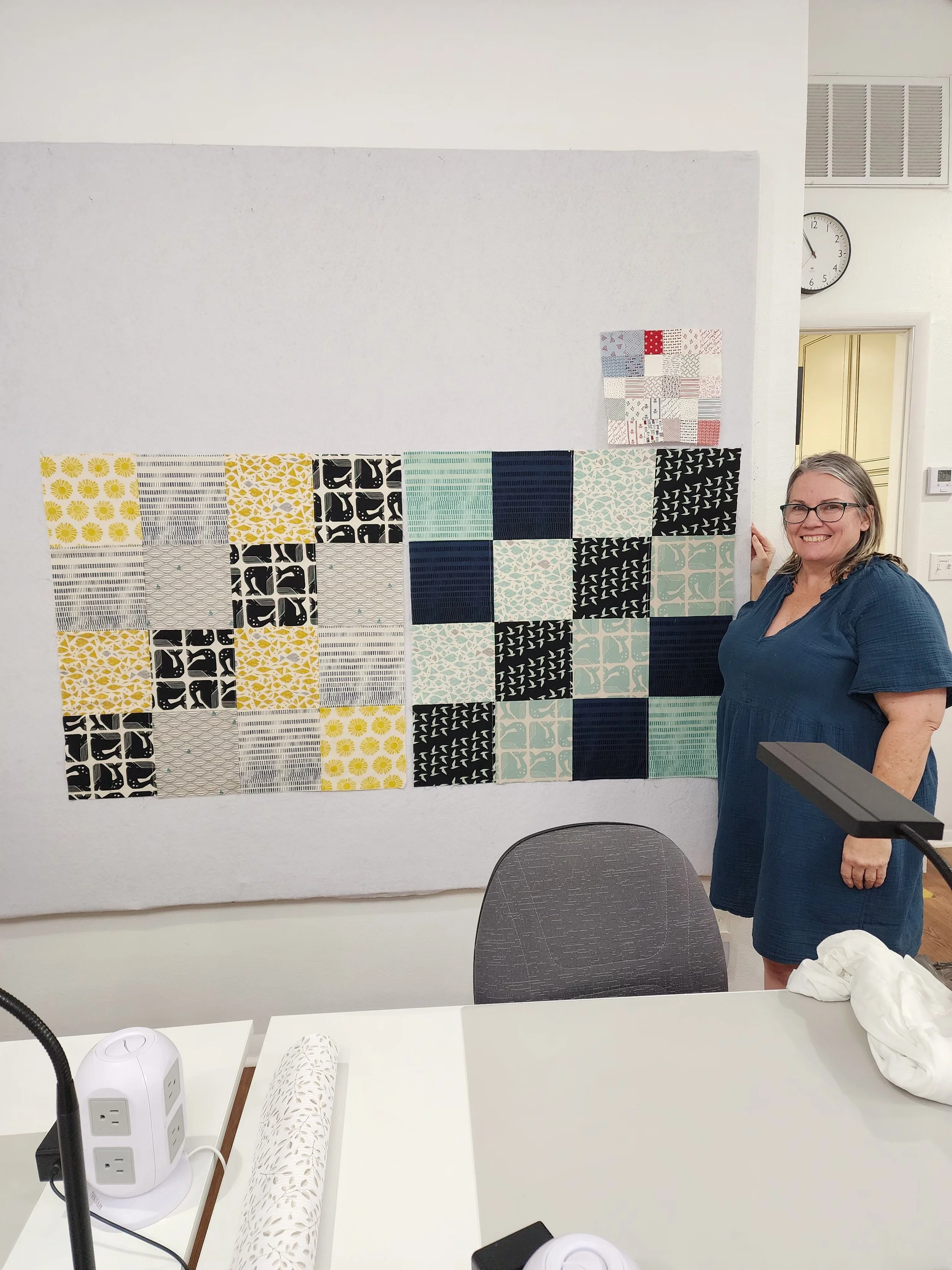 Jana with her finished baby quilt tops