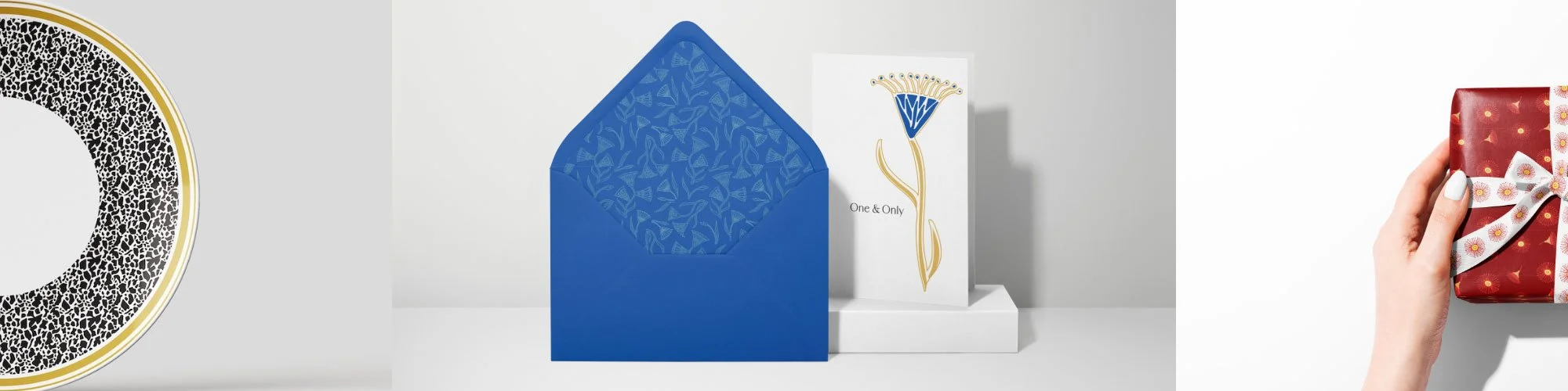 Greetings Cards, Set of greeting cards and an envelope with a blue and gold floral design, arranged on a blue surface with a gold and white floral patterned background. Commercial design solutions, Surface design, Product concepts, Product packaging 