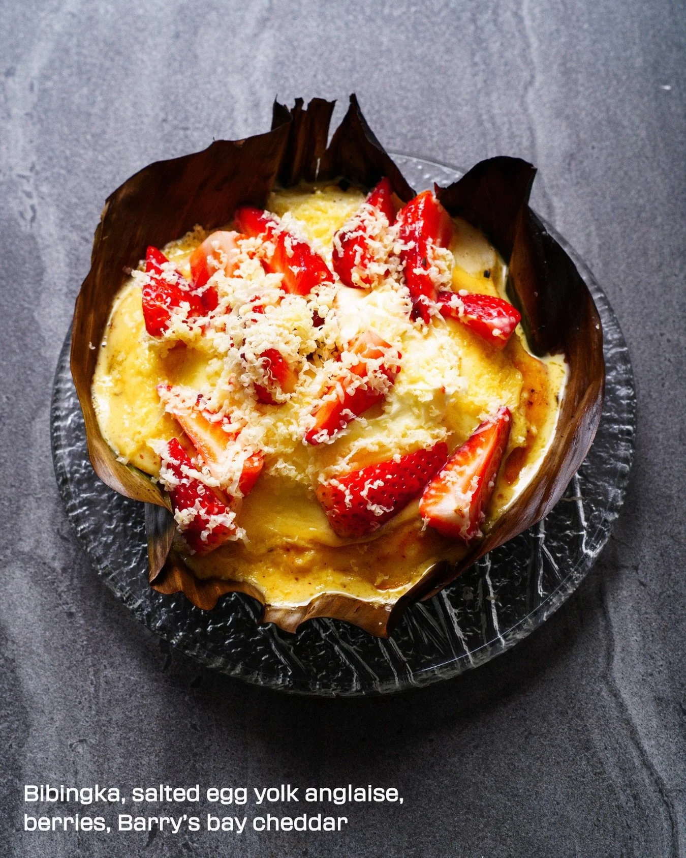Bibingka with salted egg yolk anglaise, berries and Barry&rsquo;s Bay Cheddar.

A classic made our way.

A Filipino rice cake traditionally enjoyed in holidays. It&rsquo;s soft, lightly charred, and cooked over intense heat. Ours keeps the spirit of 