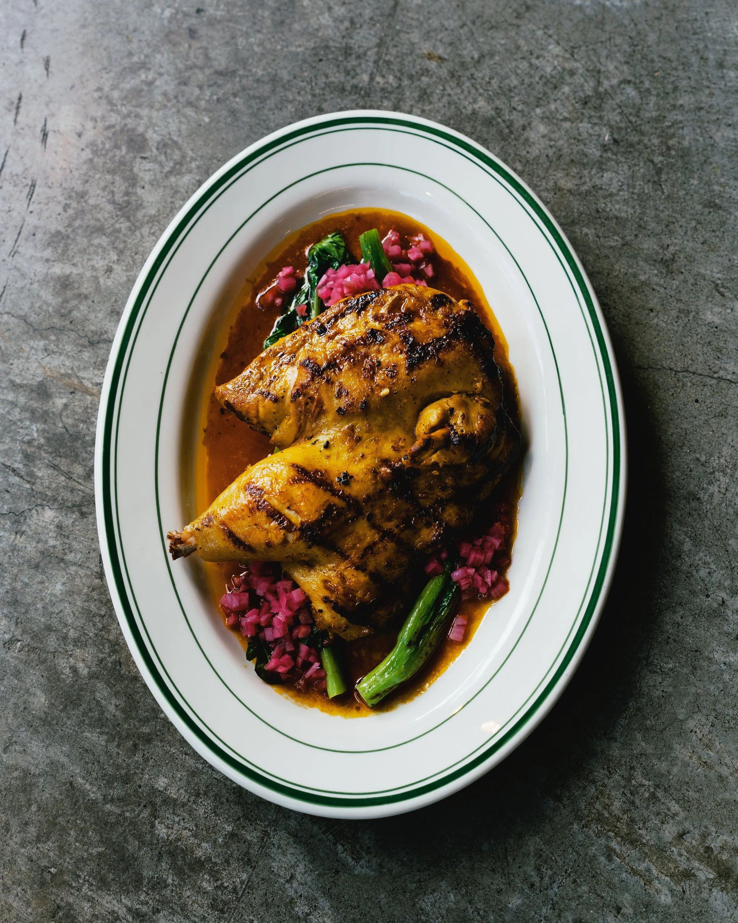 A glimpse of Bacolod.

Our Half Chicken Inasal is marinated and grilled the way we like it &mdash; smoky, deeply savoury, and full of soul. Served with kanto-style onions, annatto oil, and seasonal greens.

Simple food, done properly.

Available Mond