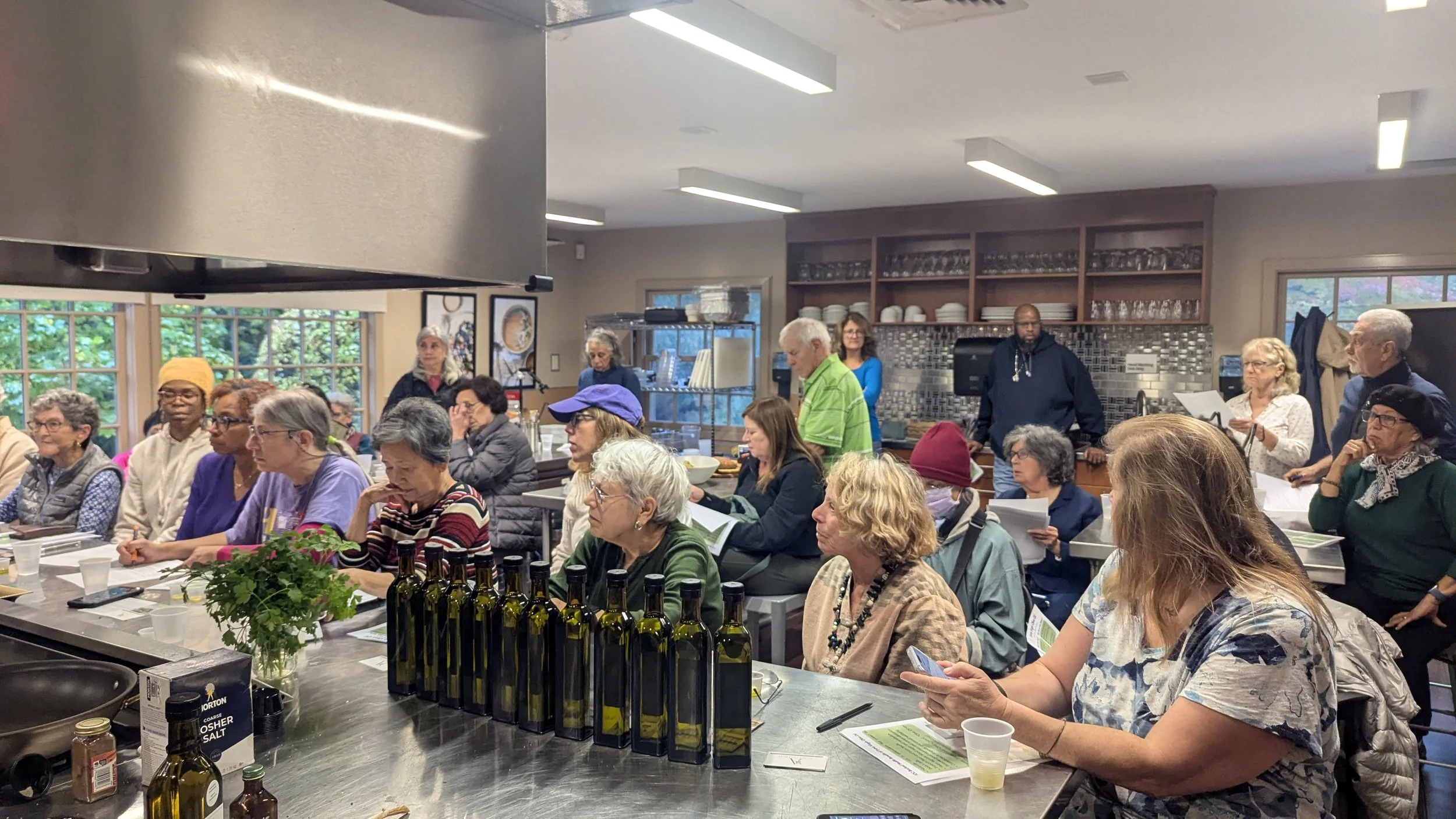 a group of people in a teaching kitchen learning about the health benefits of extra virgin olive oil in Hudson Valley  Teaching Kitchen in NY Presbeterian Hospital