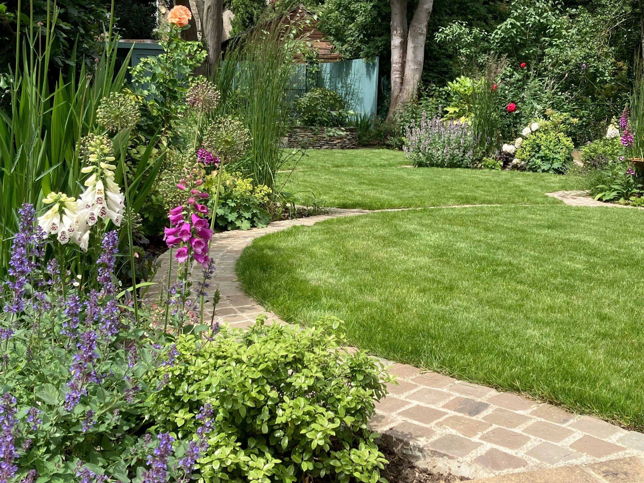 Circular inset brick pathway through garden 