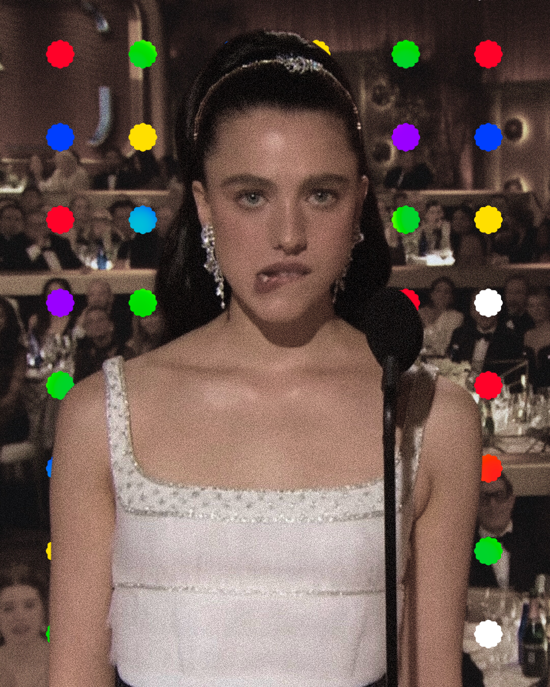 A young woman with dark hair, wearing a white dress with embellishments, sitting at a formal event.