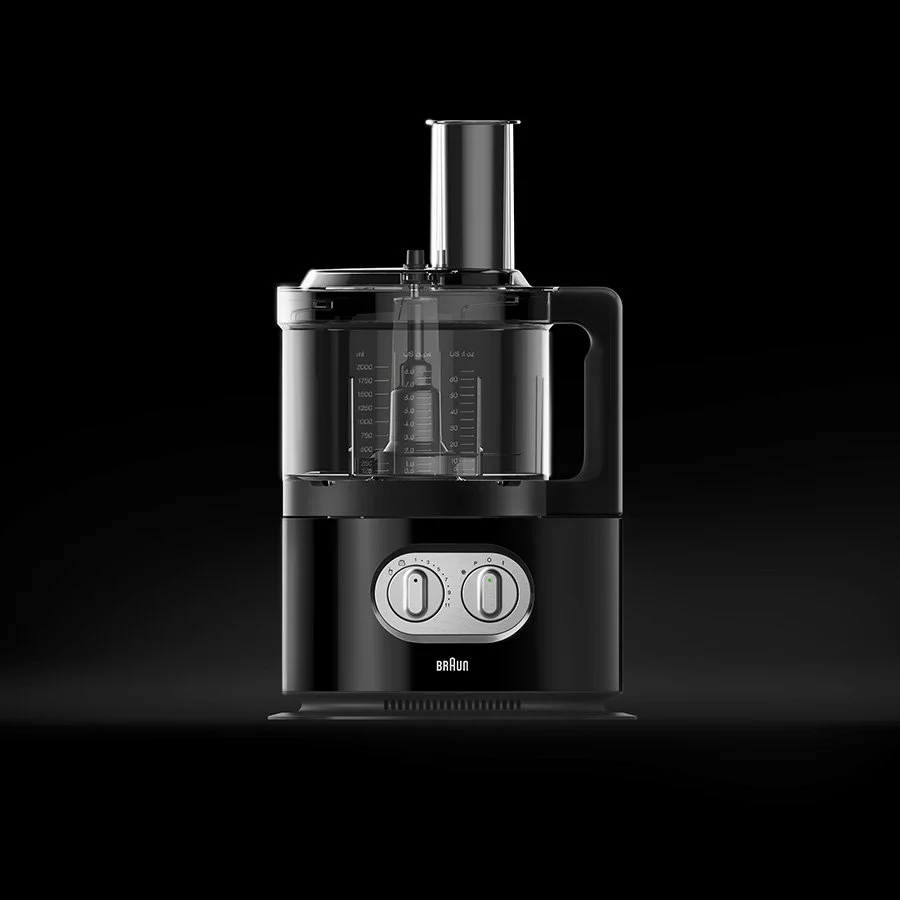 Black and silver electric food chopper with control dials on a dark background.
