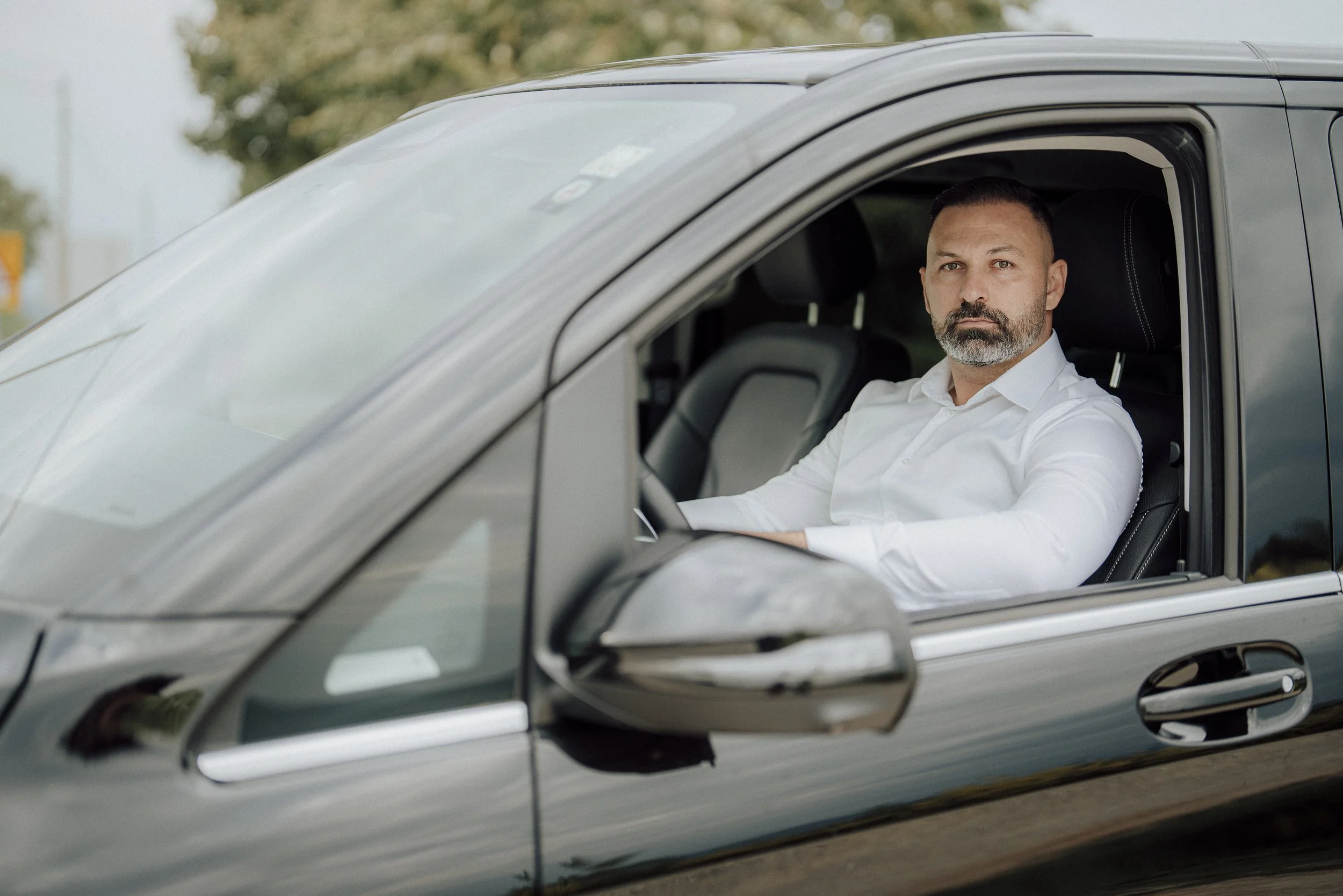 Relaxing in a luxury Mercedes-Benz chauffeur vehicle after a gourmet dinner.