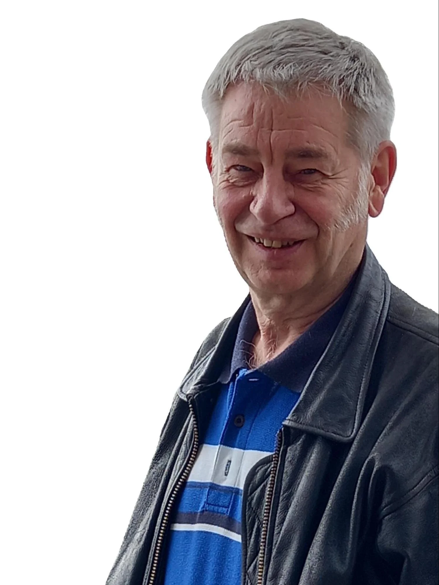 Smiling older man with gray hair, wearing a black leather jacket and a blue striped polo shirt, standing against a white background.