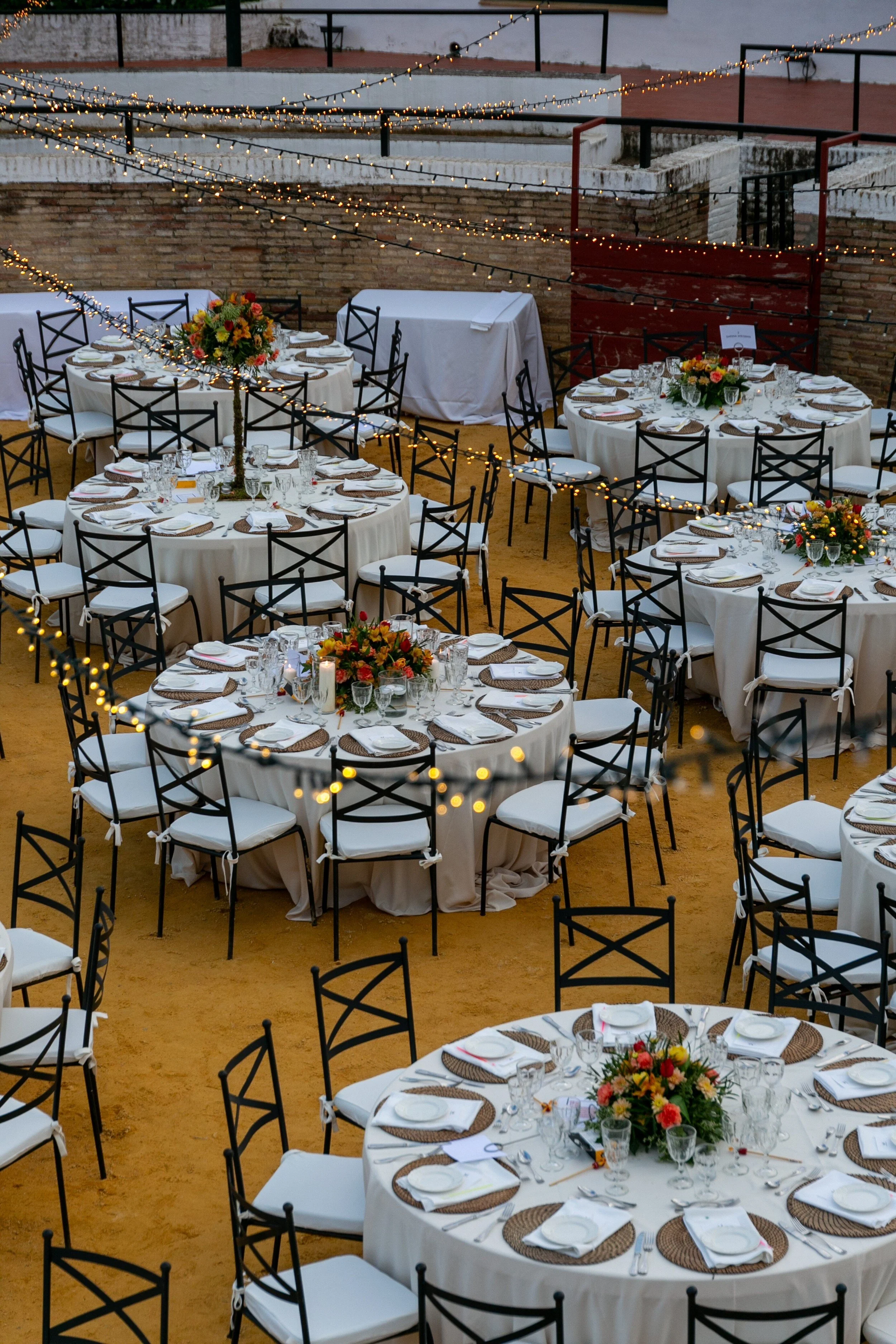 Wedding banquet in bullring in evening event with hanging lights decorations