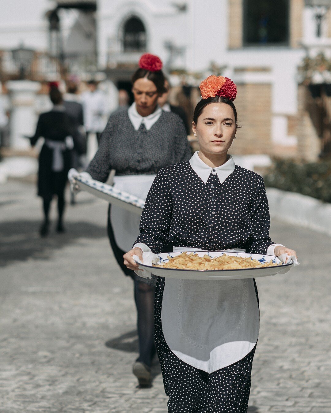 Waitresses in catering service with hors d'oeuvres on trays for wedding cocktails