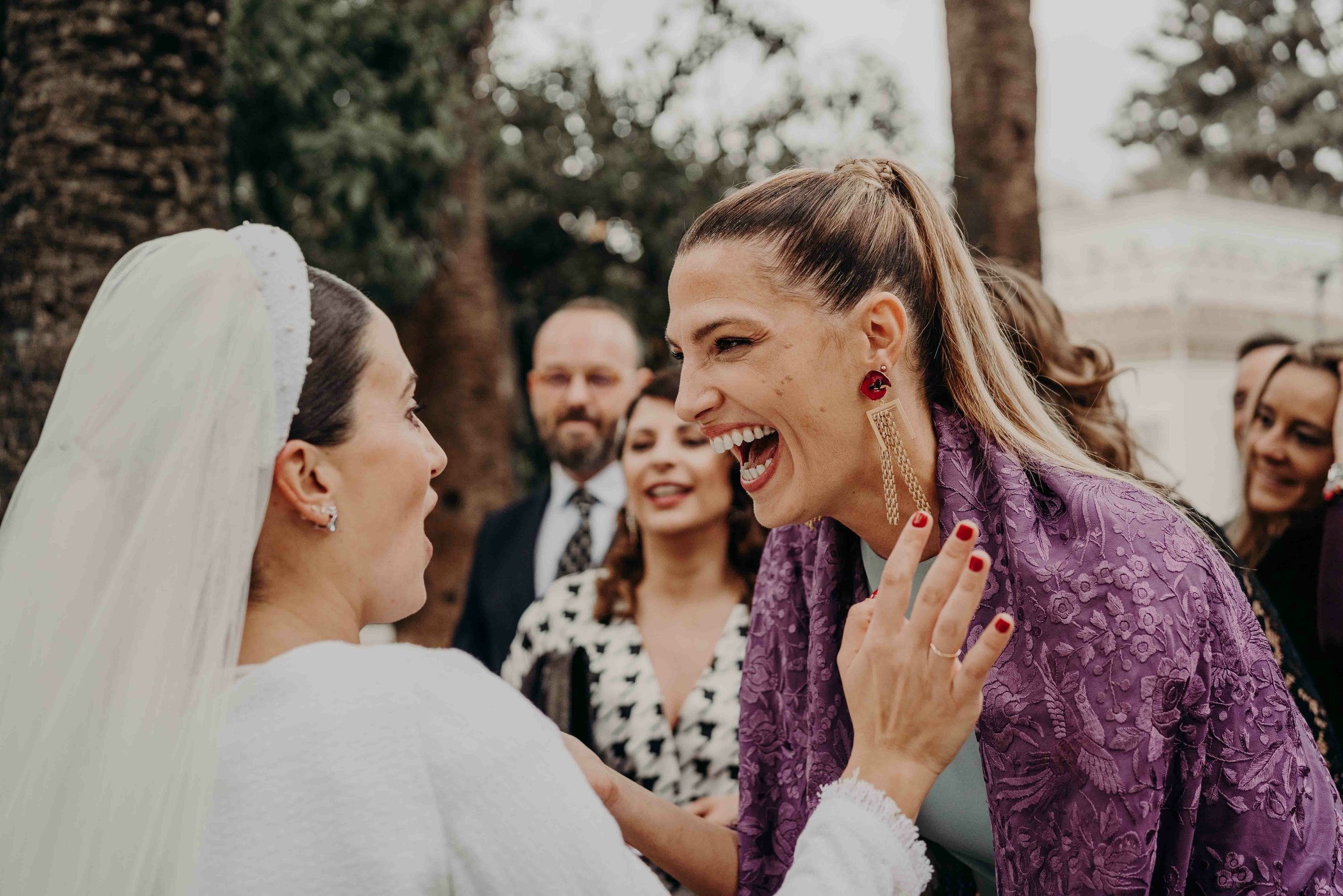 Friends laughing with each other on the wedding day