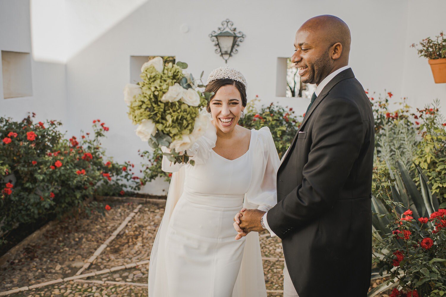 Newlywed couple smiling in charming event corner