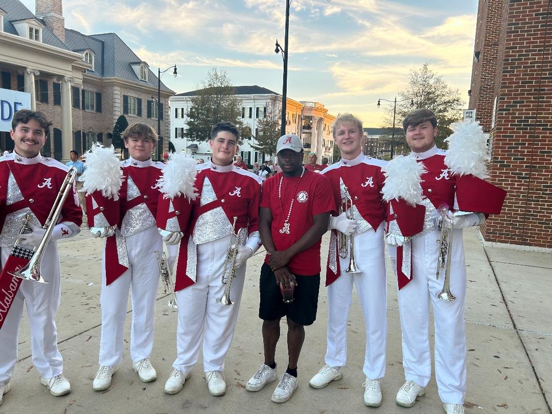 Kenyon grabs a photo with members of the Million Dollar Band