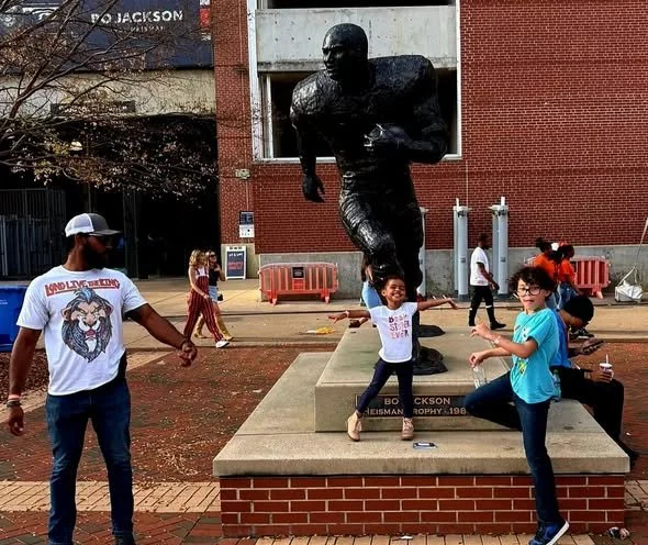 Grey and family outside the stadium
