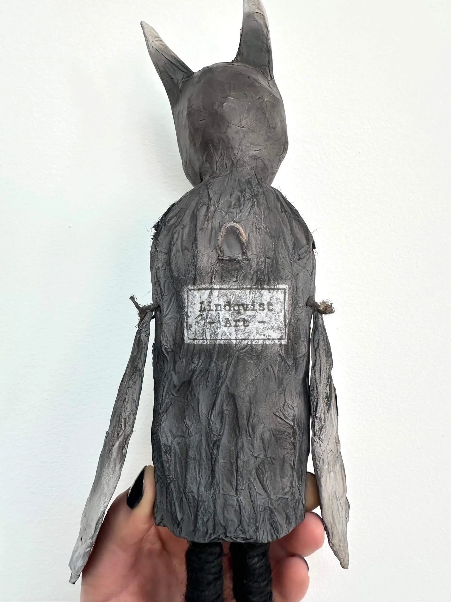 Crow Creature sculpture showing hanging loop and Lindqvist Art stamp on the back